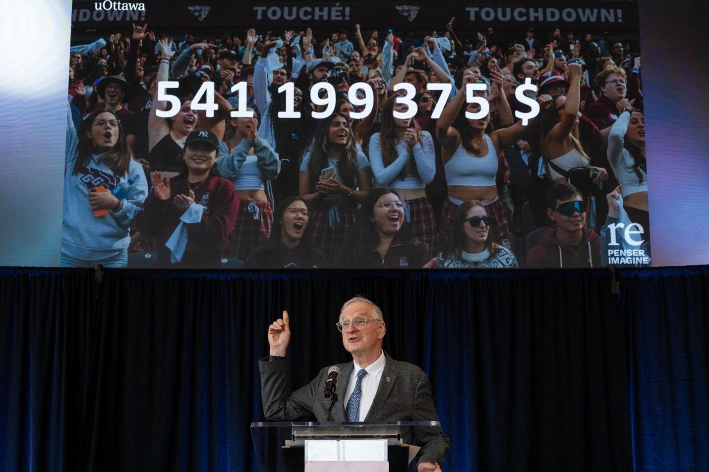 Jacques Frémont announcing the total amount raised for the campaign: $541,199,375