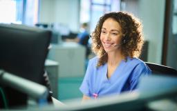 A nurse looking at a screen