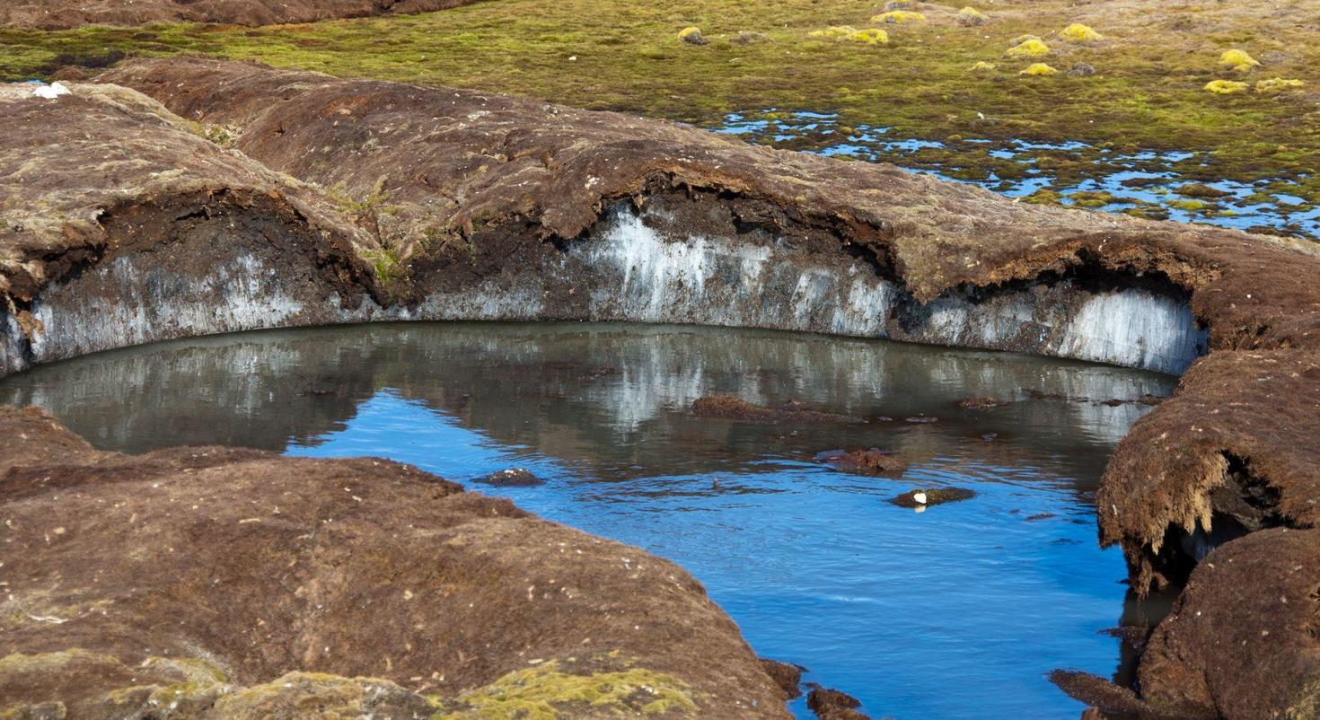 Soil affected by permafrost with a body of water in the centre