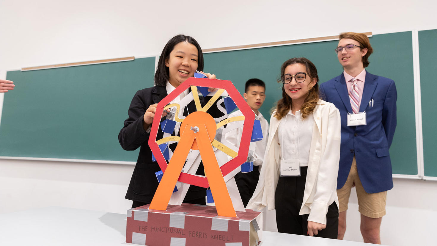 Three student showcasing their math project.