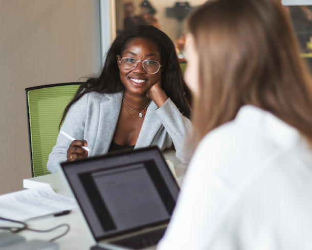 Two women sitting at a computer working