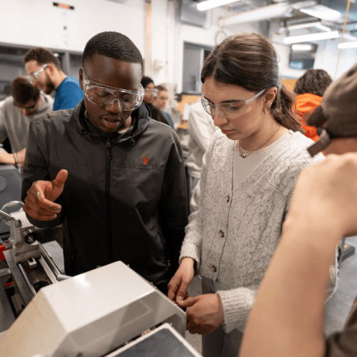 student explaining how to use a machine.