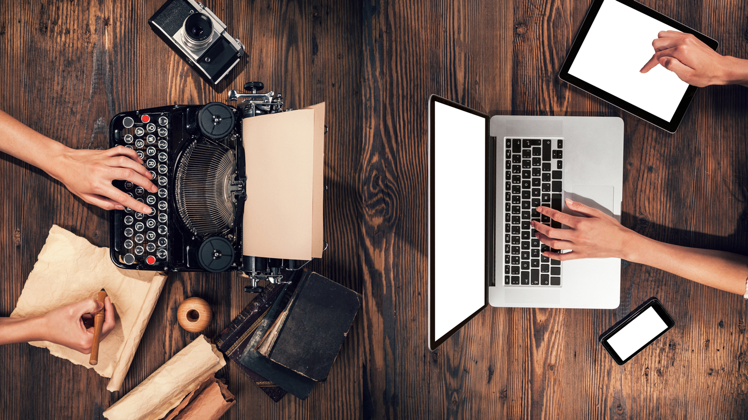 people writing on a laptop and a typewriter 