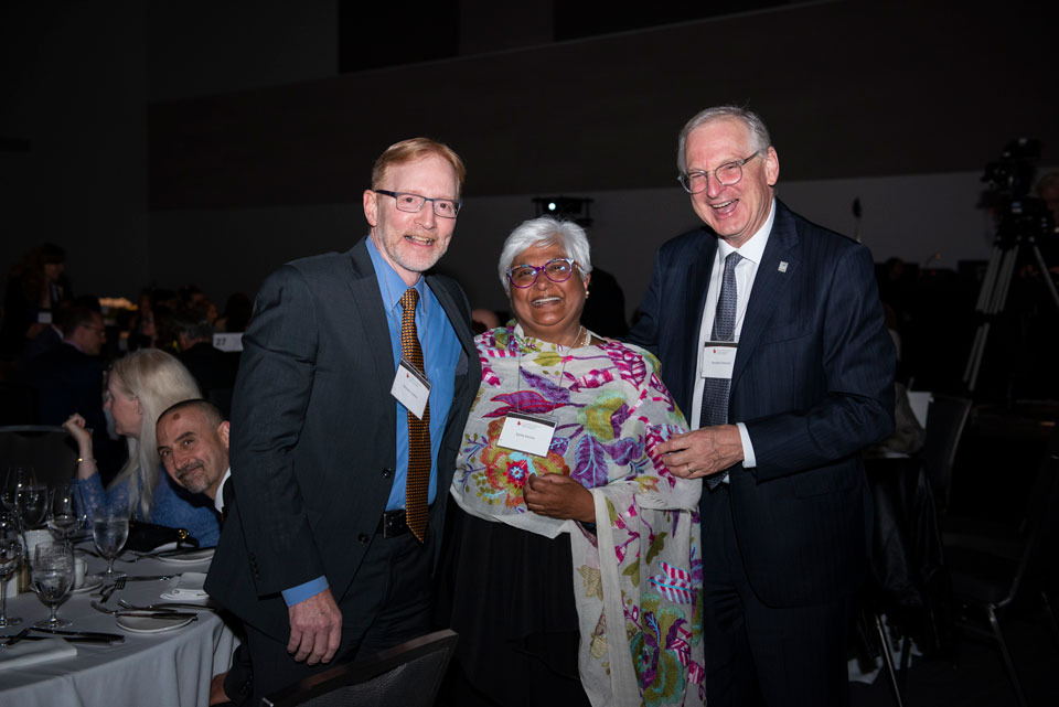 Three people pose for a picture at the CMHF Induction ceremony.