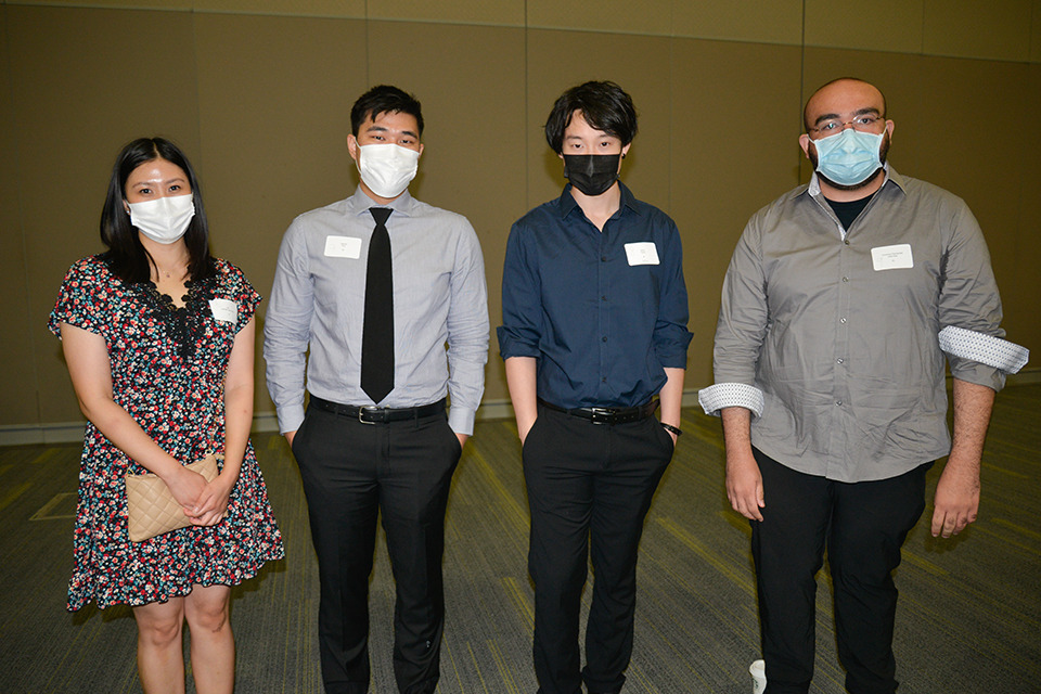 Four medical learners pose wearing face masks.