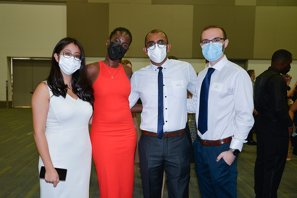 Four medical learners pose wearing face masks.