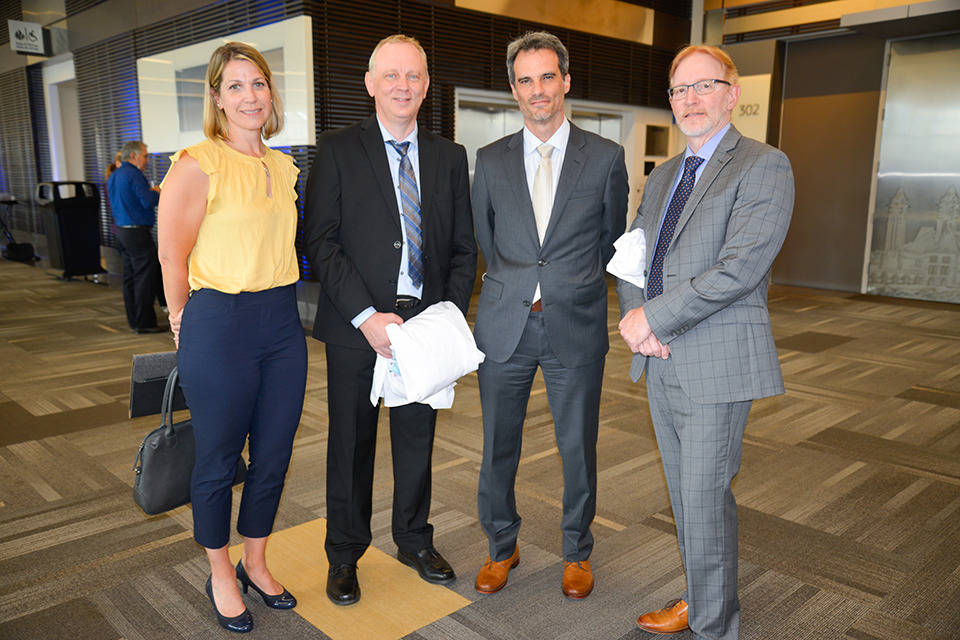 Four faculty members pose.