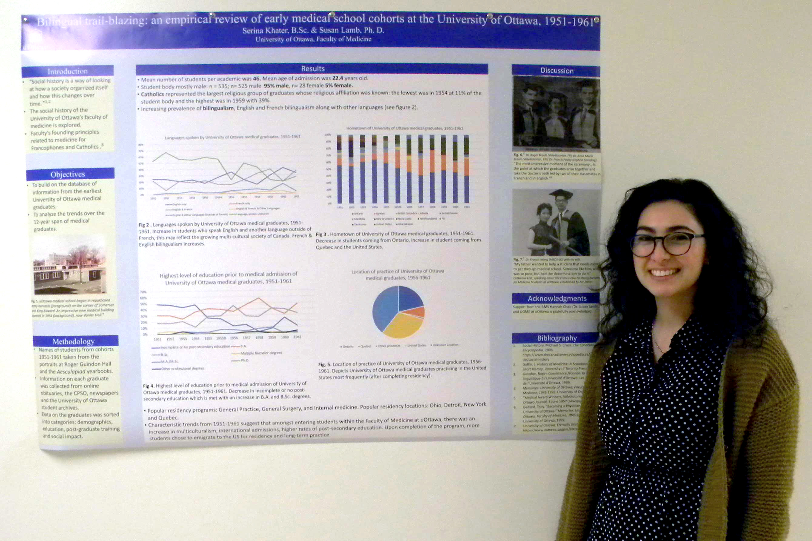 Photo of Serina Khater standing in front of her poster.