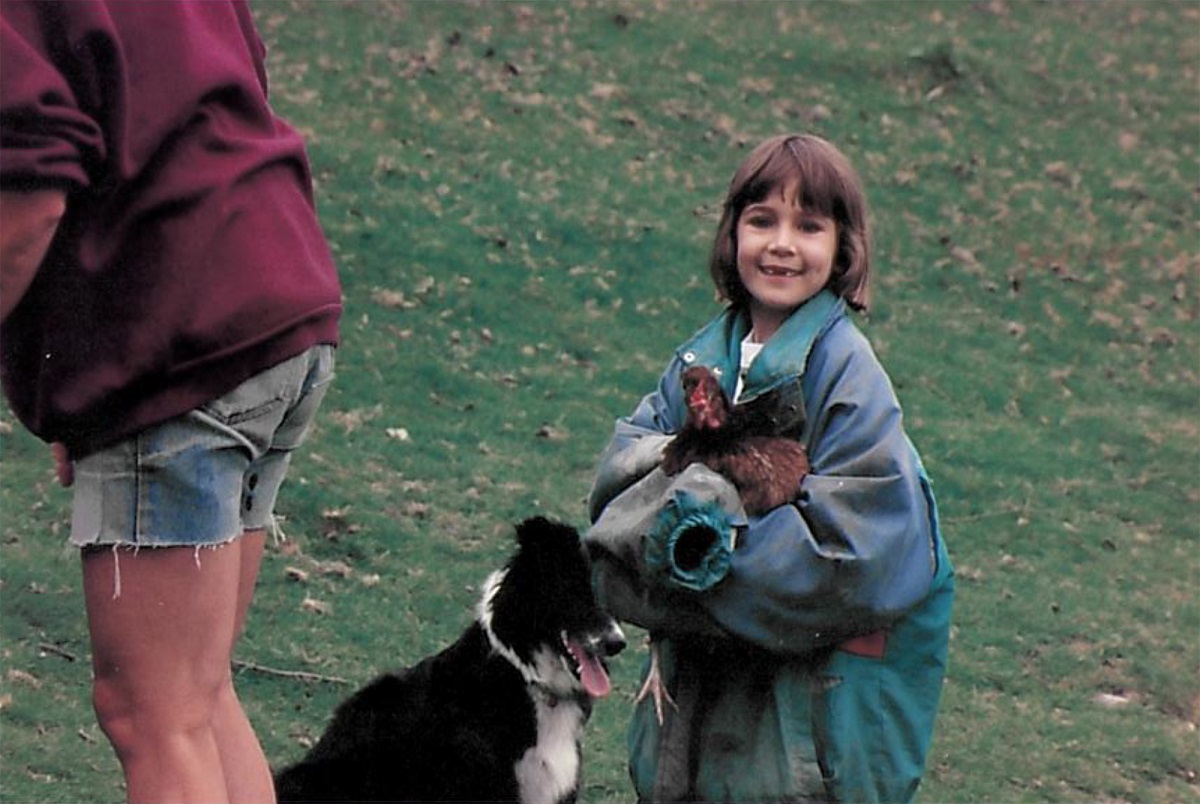 Sarah as a child holding a rooster