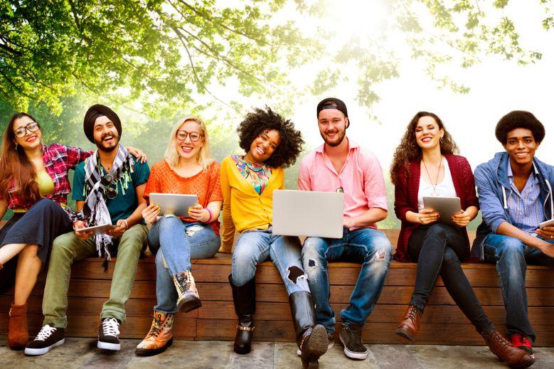 Group of students sitting on a bench outside