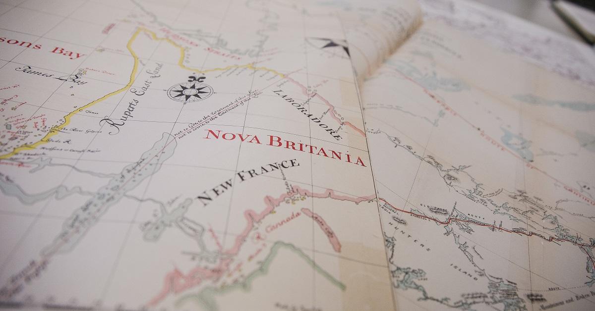 The words “New France” and “Nova Britania” are visible on an old map.