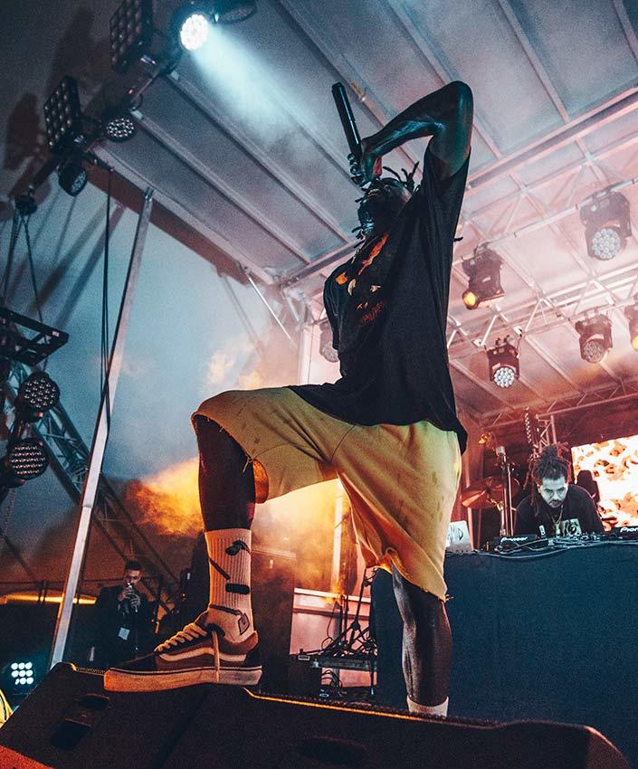 Jazz Cartier on stage, singing into a microphone.