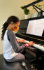 A deaf girl with cochlear implant playing piano.