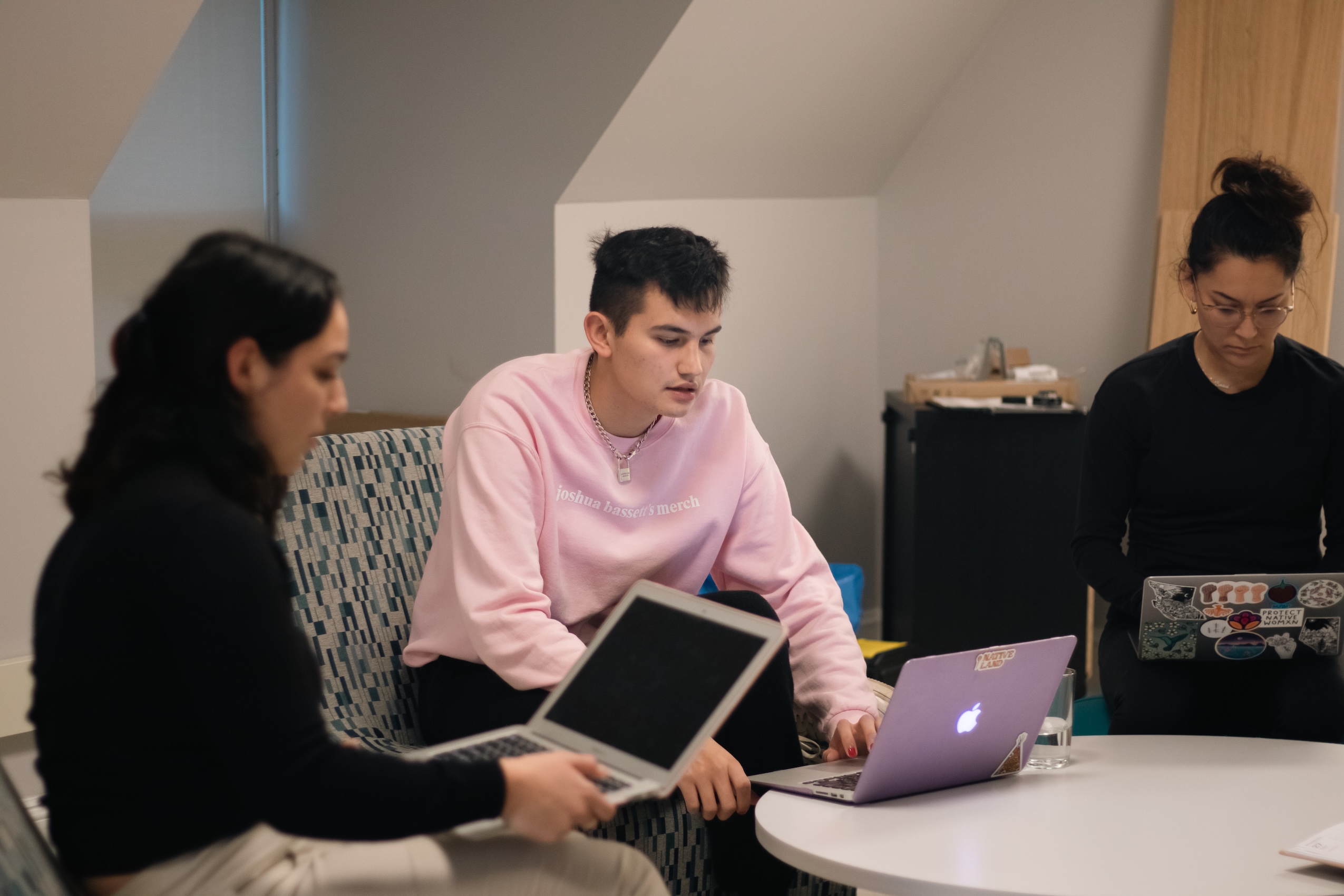 Students working on their laptop, sitting in the Library