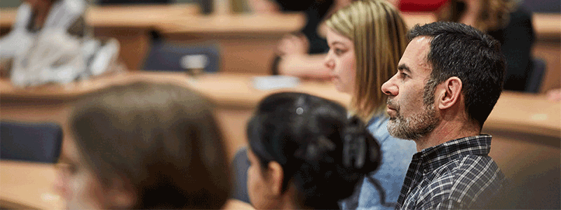 Students sitting in a classroom listening to lecturer, not shown